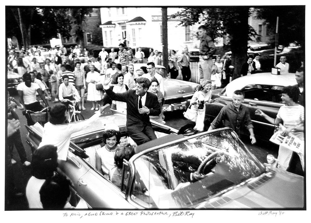 Bill Ray (b. 1936): Note: Description Updated 11/23. President John F. Kennedy and the First Lady. B&W, 1960. Fiber-based silver gelatin. Older print. Framed. President John F. Kennedy and Jacqueline Kennedy, sitting in
