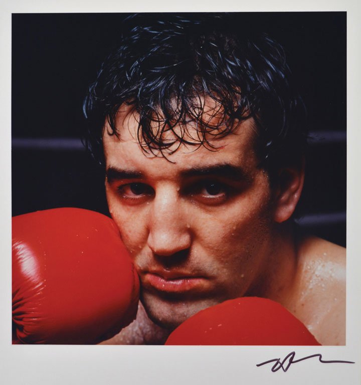 Gerry Cooney: Note: Description Updated 11/22. Color, 1982. Vintage Type "C" print. Gerry Cooney photographed just before he fought Larry Holmes for the Championship title. Signed in ink by Neil Leifer. 14 x 11in.
