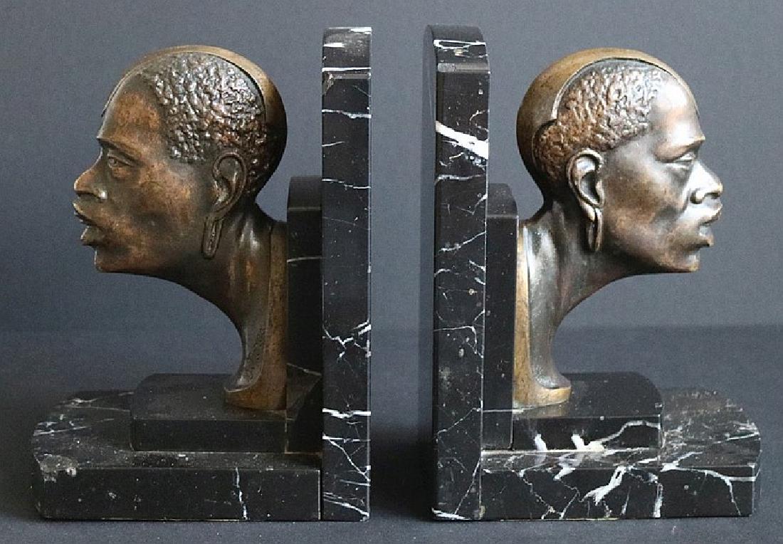 Sylvain NORGA (1892-1968): Sylvain NORGA (1892-1968); Book rests bronze African heads; H 16.5 cm