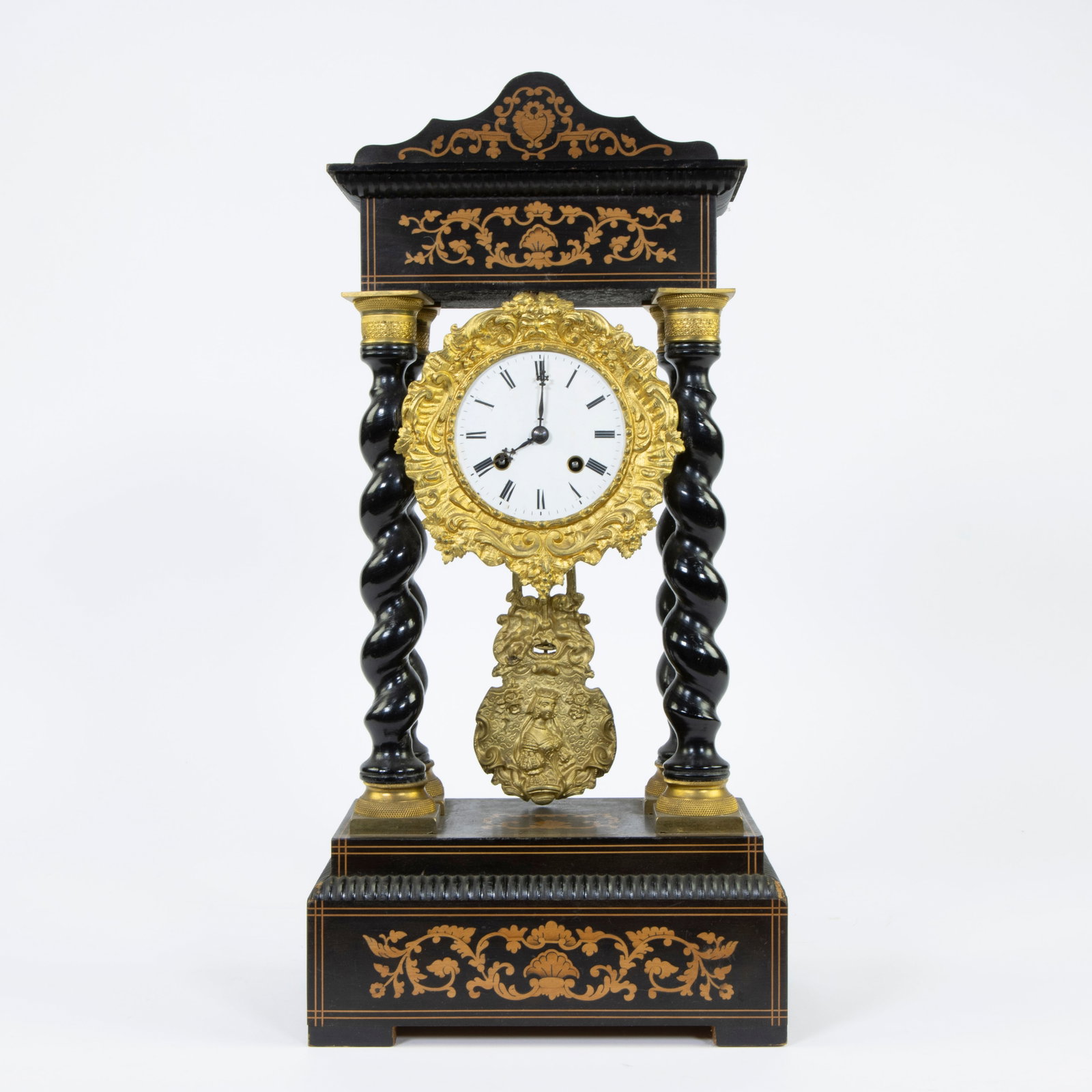 A Napoleon III column pendulum clock of black lacquered wood and gilt brass decorated with: A Napoleon III column pendulum clock of black lacquered wood and gilt brass decorated with marquetry, 19th century Een Napoleon III kolompendule van zwartgelakt hout en verguld messing versierd met ma