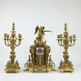 Gilt bronze mantelpiece set in Louis XV style, consisting of a pendulum with winged figure of (1 of 4)