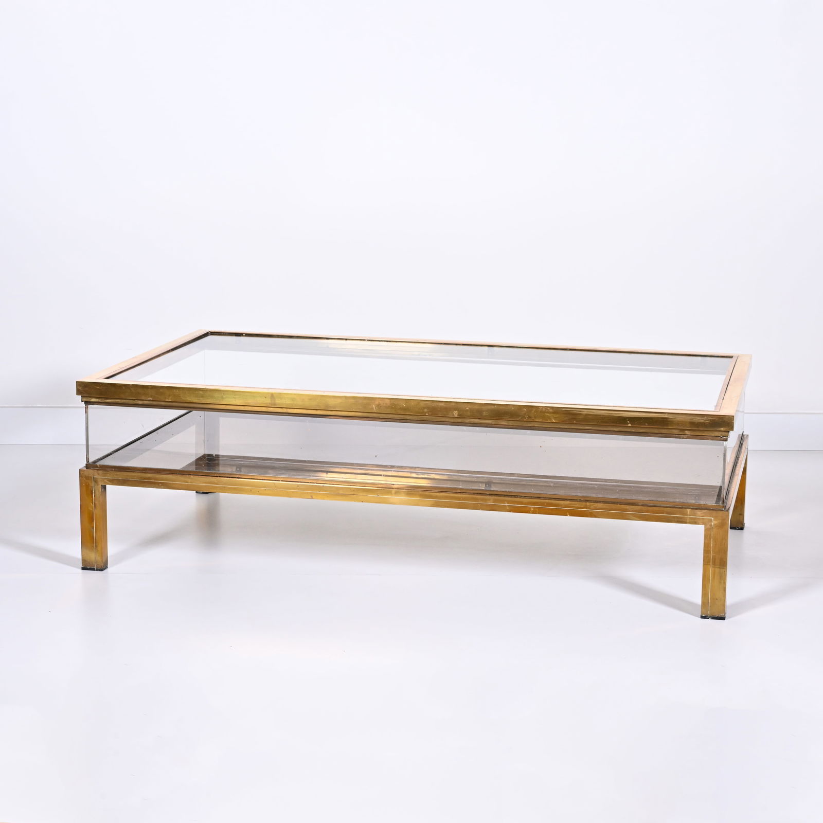A vintage glass and brass display cabinet coffee table with extendable top, in the style of Maison (1 of 4)