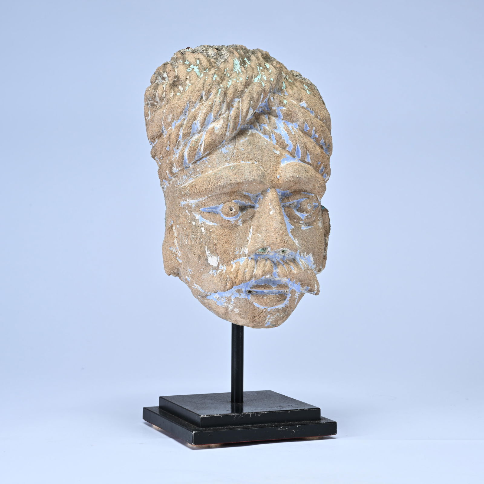 Carved stone head with traces of polychromy (azurite or lapis lazuli) in a Greek-Buddhist style. (1 of 6)