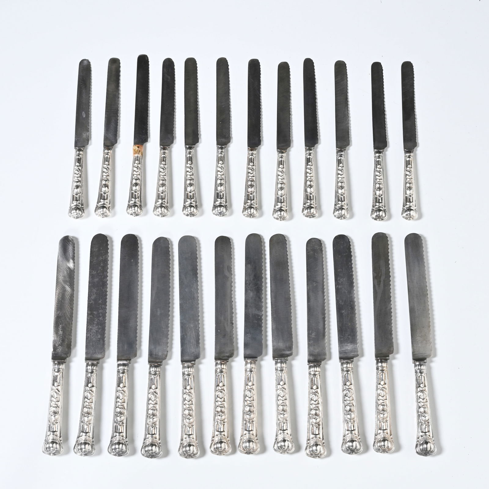 24 silver knives with ornamented silver handles and steel blades with serrated edges (1 of 8)