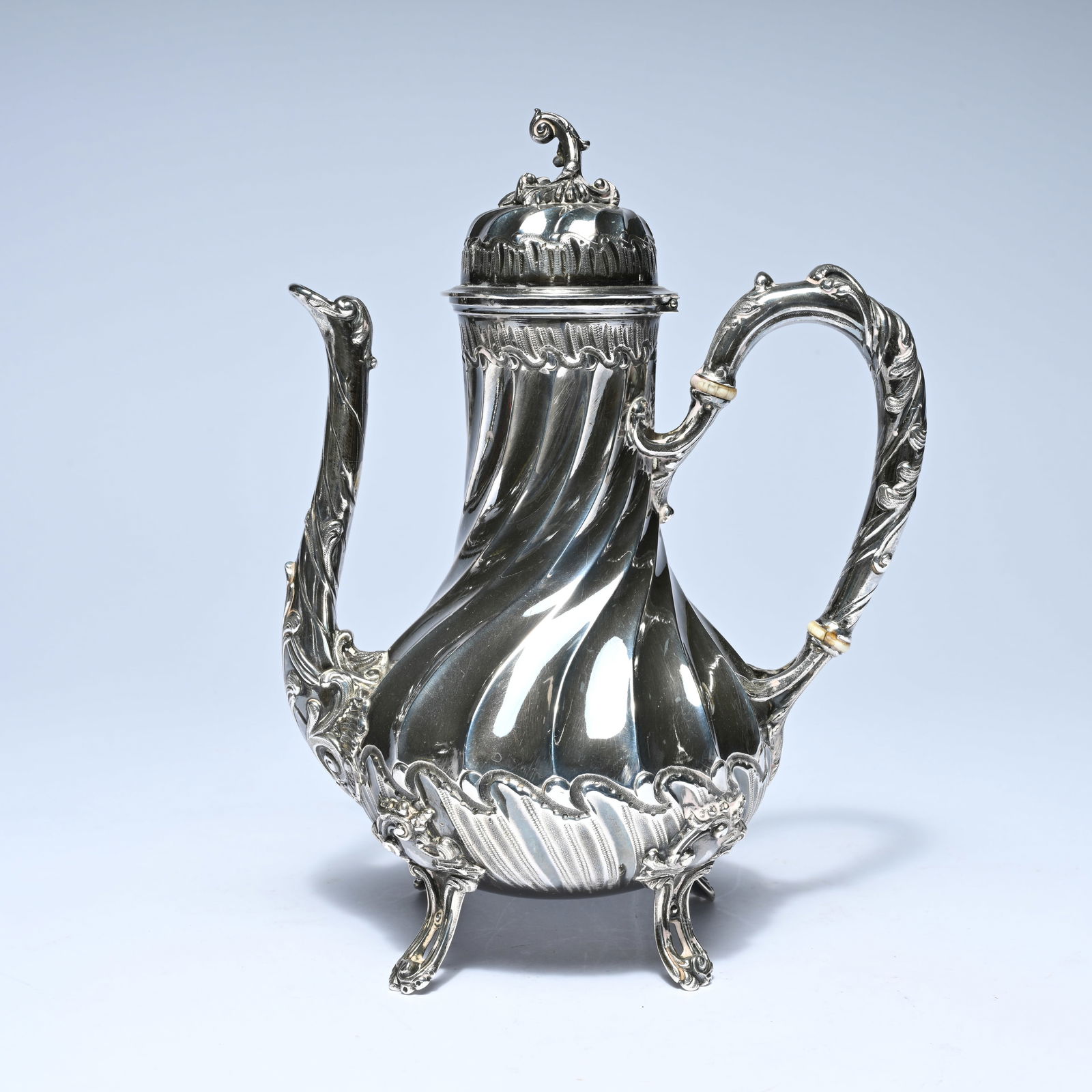Silver coffee pot with a pear-shaped, twisted body, resting on three graceful feet. It features a (1 of 7)