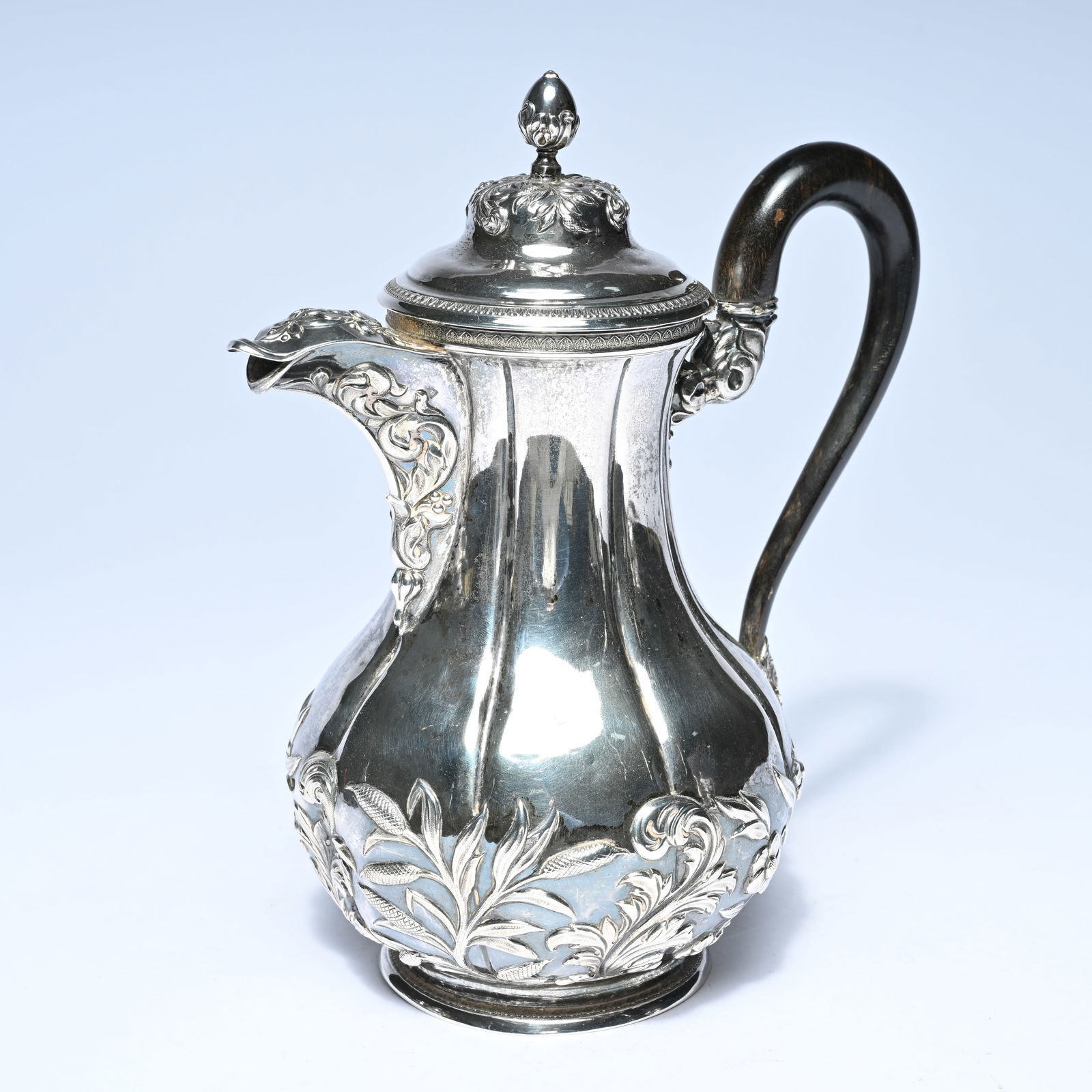 Silver coffee pot with rich floral and rocaille motifs, a gracefully shaped spout, and a wooden (1 of 9)