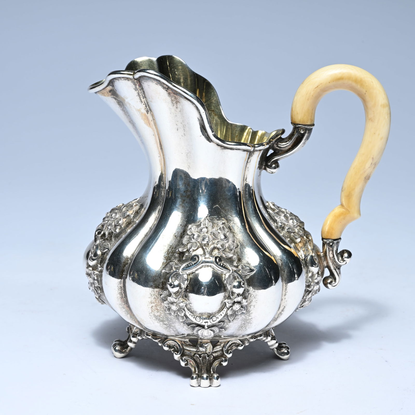 Silver cream jug, Wolfers, pear-shaped, wavy-shaped cuve, richly decorated with floral garlands and (1 of 7)
