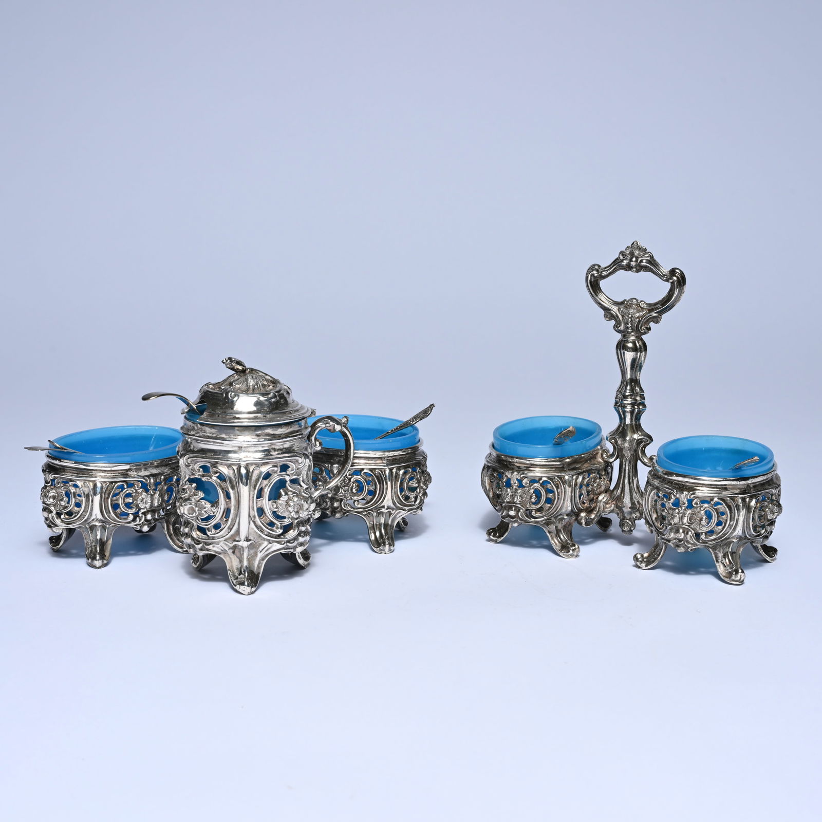 Silver mustard and salt set with blue glass inserts, richly decorated with openwork rocaille and (1 of 11)