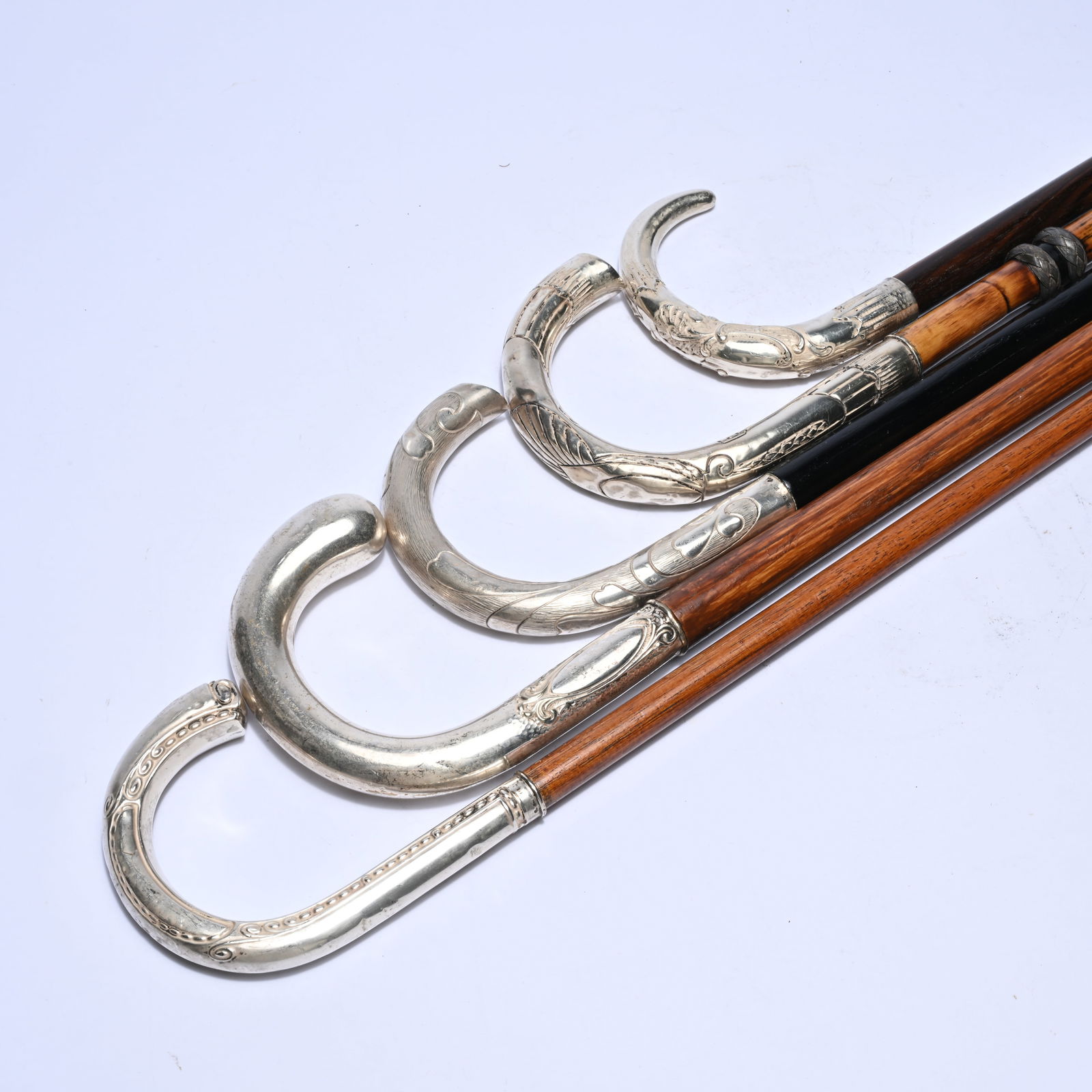 5 wooden walking sticks with elegant curved silver crutch handles richly decorated with ornamental (1 of 4)
