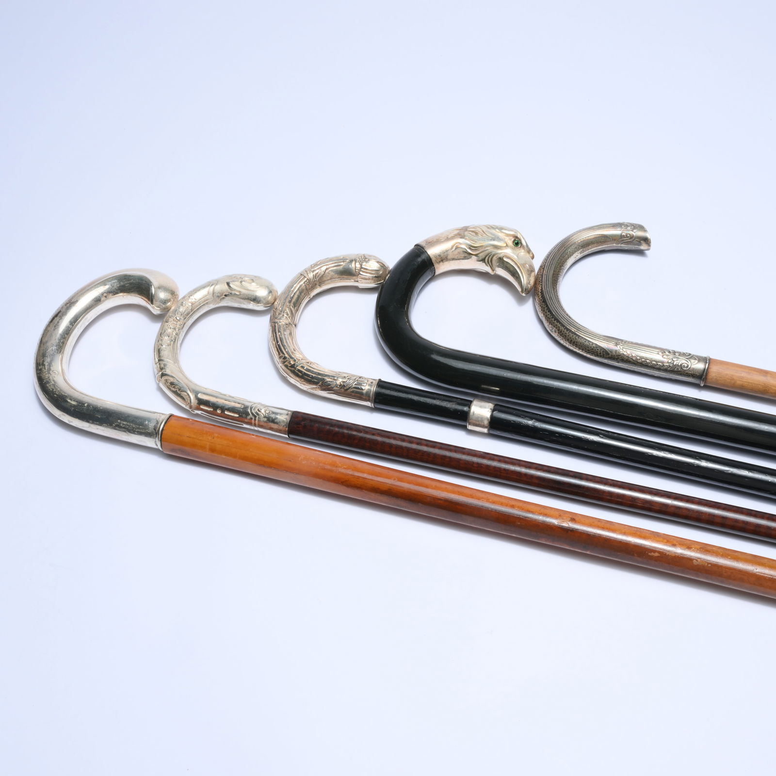5 walking sticks with curved silver handles, some richly engraved and one striking example with a (1 of 9)