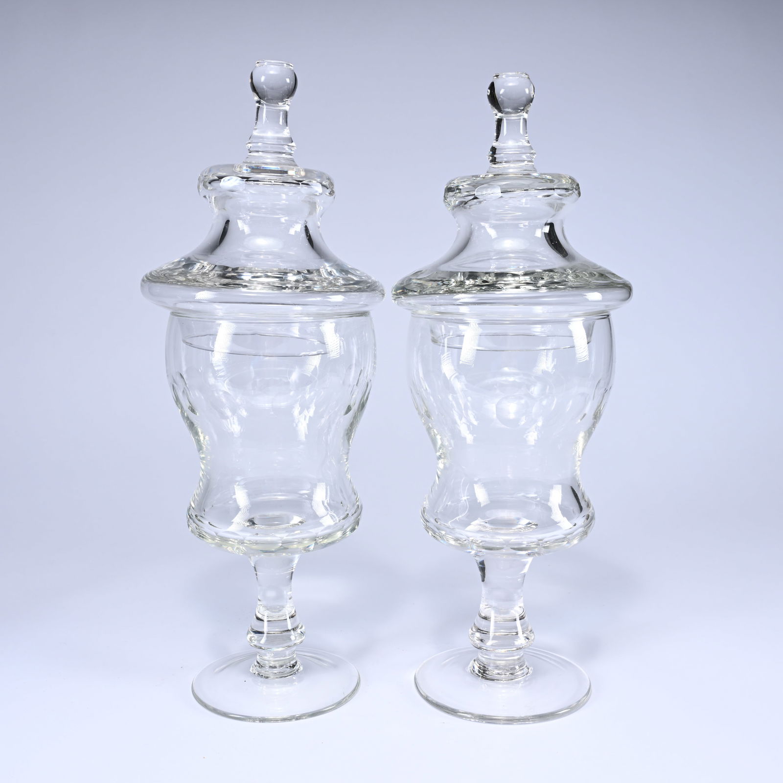 A pair of elegant 19th century clear glass footed covered jars with a fluted, slightly (1 of 6)