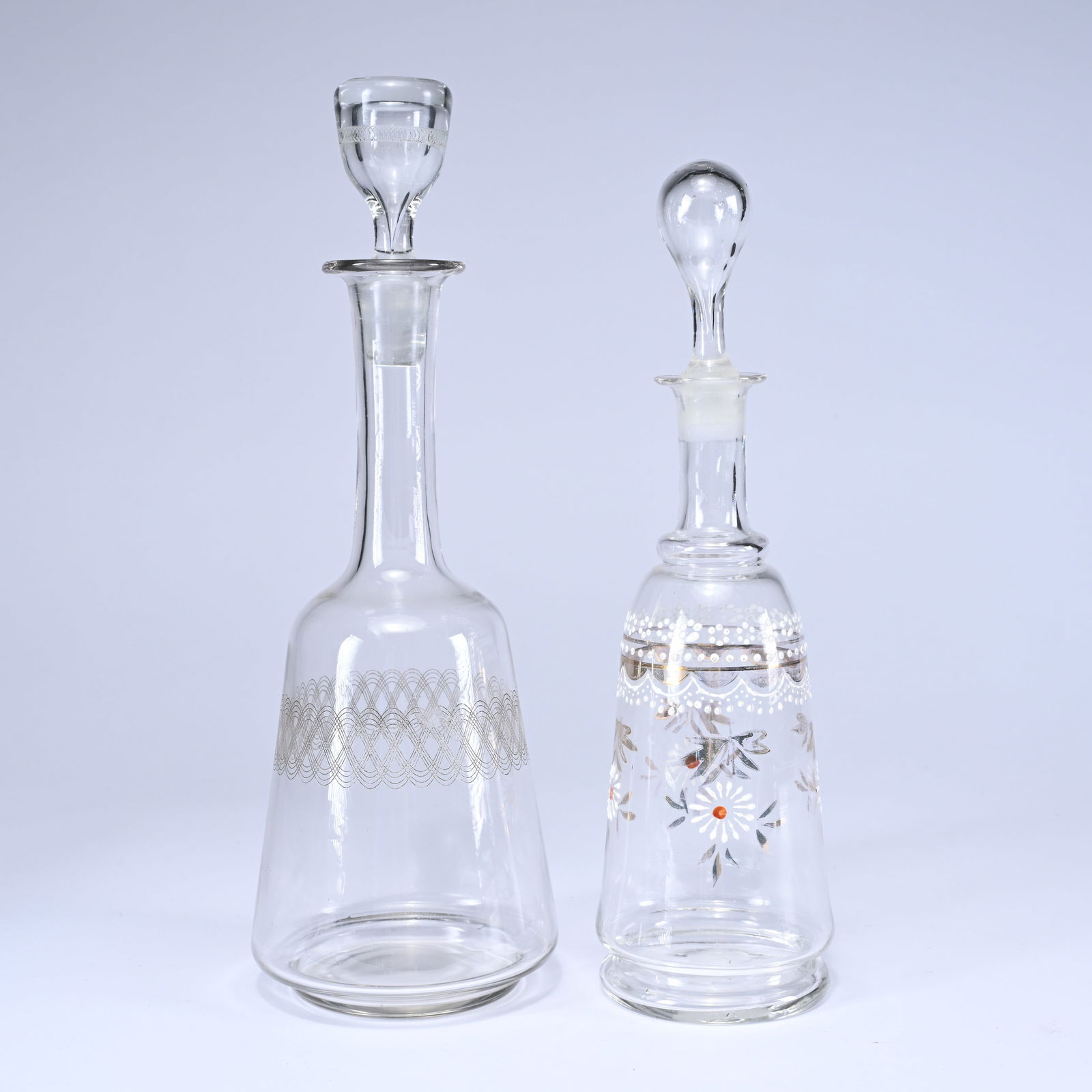 2 antique glass decanters with stoppers, made of clear glass and decorated with enamel and geometric (1 of 5)