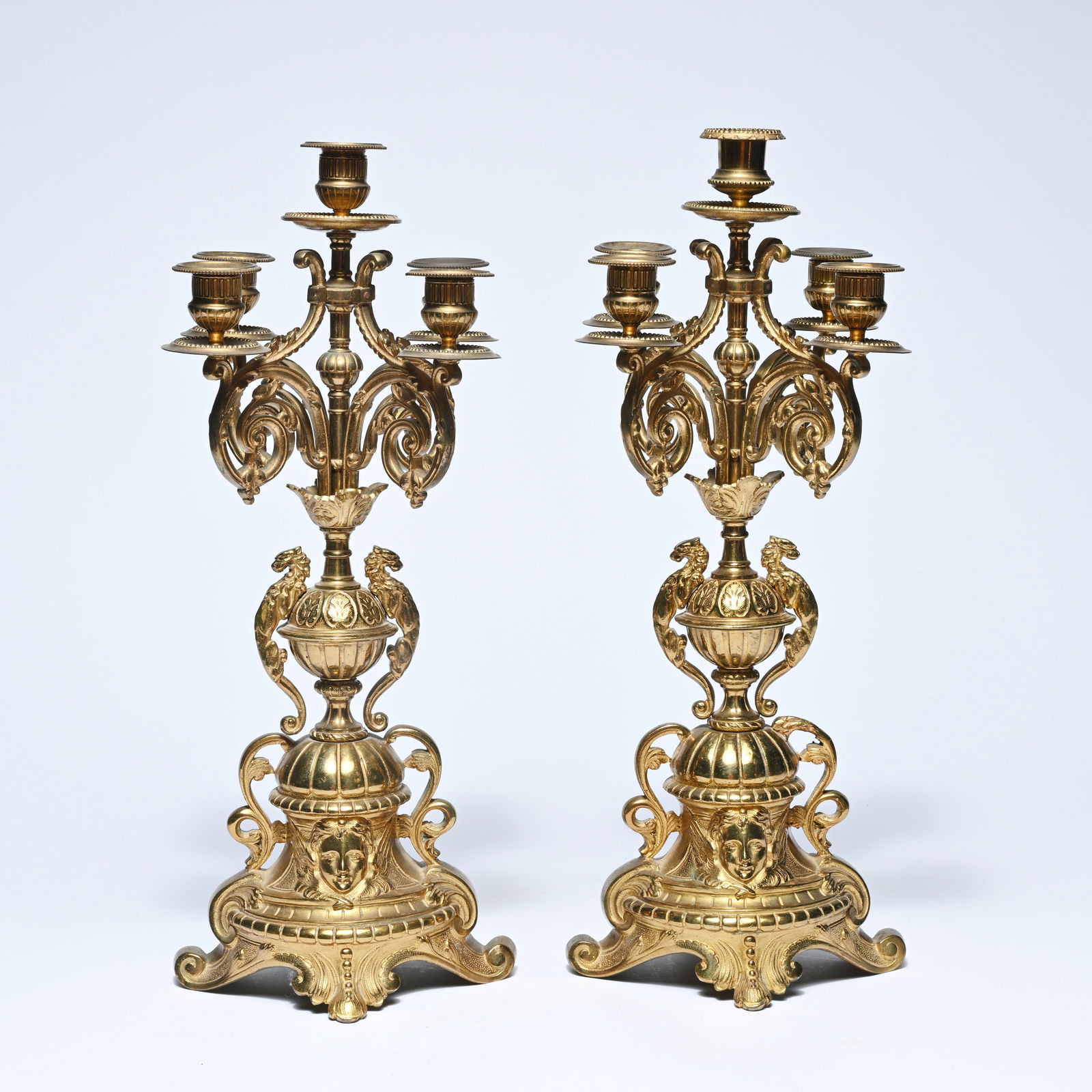 A pair of richly decorated five-light gilt bronze candlesticks with acanthus volutes, mask heads and (1 of 5)