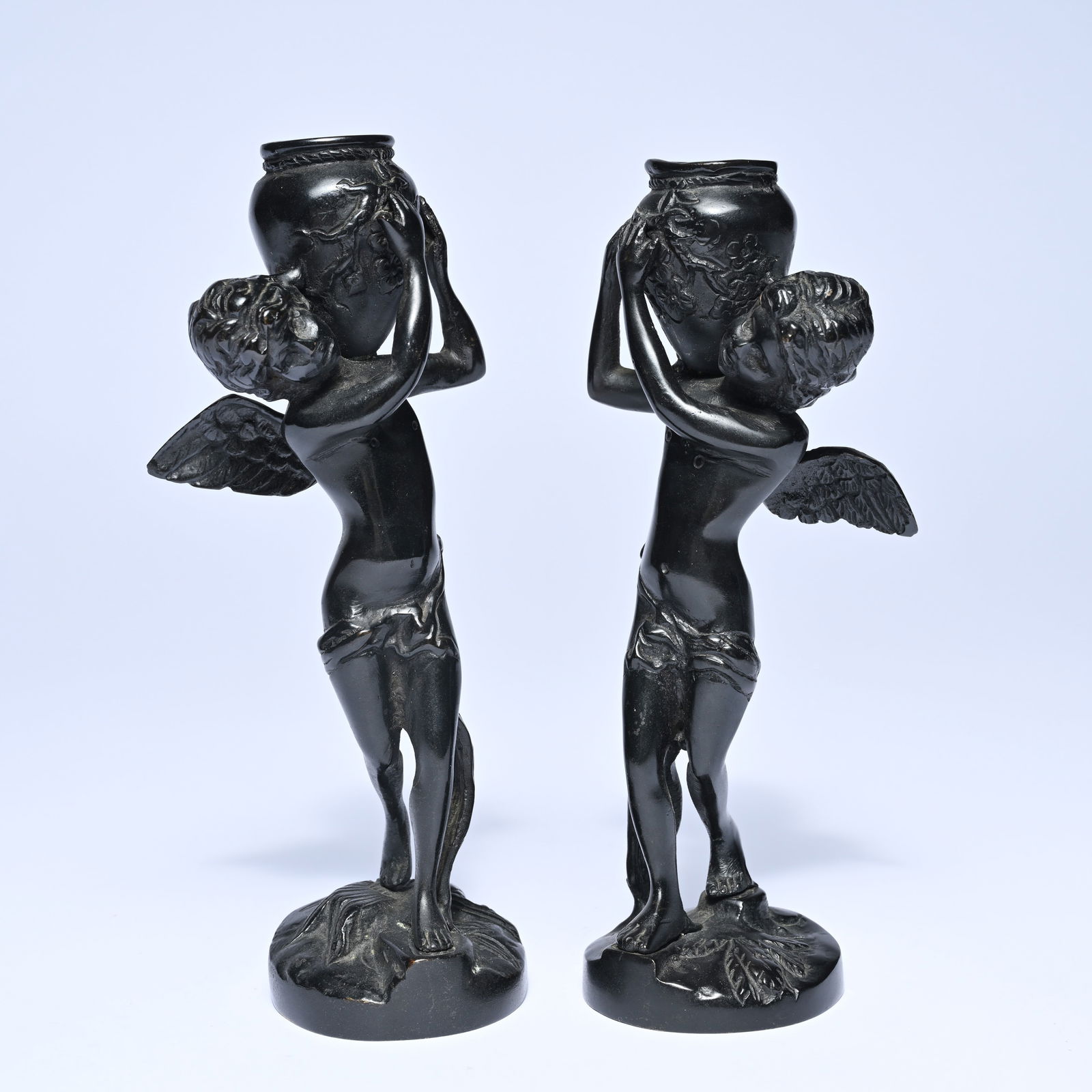 2 bronze candlesticks with black patina, depicting cherubs carrying a vase-shaped candlestick (1 of 5)