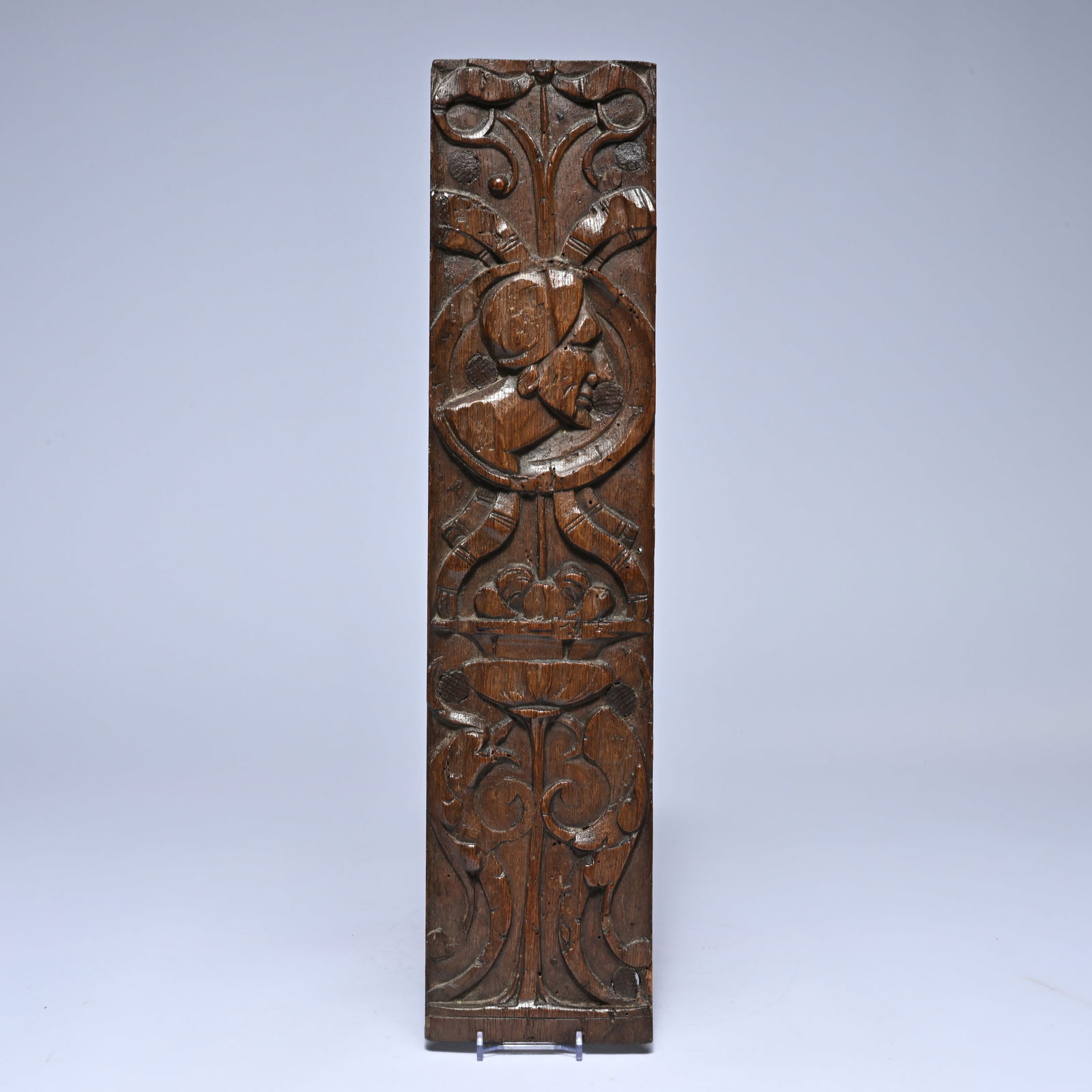 16th century oak panel with deeply carved, symmetrical leaf and scroll ornamentation around a (1 of 2)