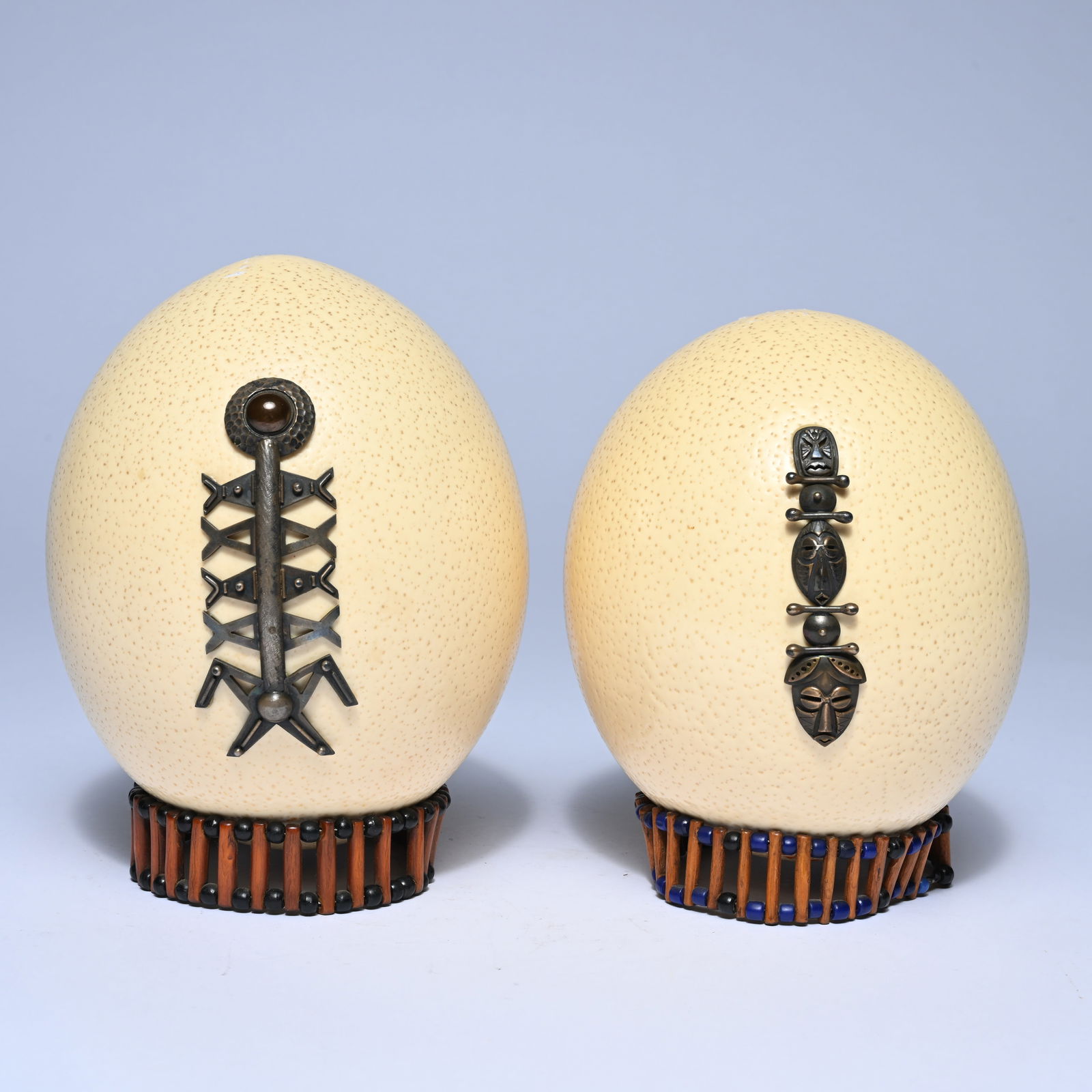 Pair of ostrich eggs with metal mask motifs, tribal art, West-Central Africa (1 of 5)