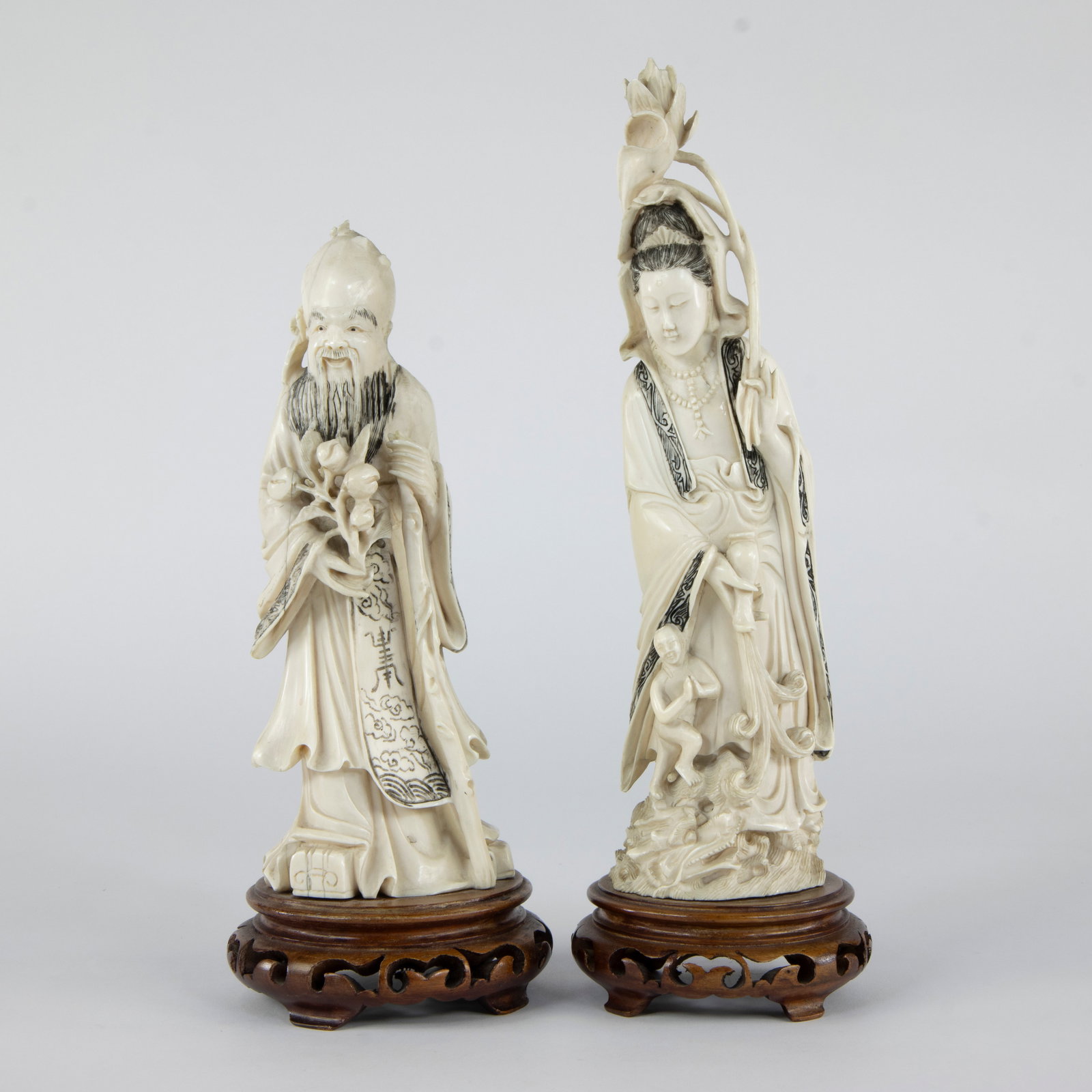 Two ivory statues of Shoulao with a staff and peach in his hand, and Guanyin with a lotus flower (1 of 5)