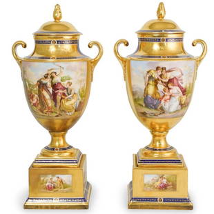 Pair of Large 19th C. Royal Vienna Porcelain Urns: Pair of Large 19th C. Royal Vienna Porcelain Urns. They measure H: 18 1/2" W: 7 1/2". Features a gold ground with cobalt blue accents and figural portrait with women in landscape, signed with Royal Vi