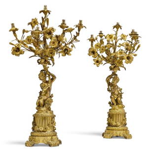 Pair of 19th C. French Figural Gilt Bronze Six Light Candelabras: Pair of Large 19th C. French Figural Gilt Bronze Six Light Candelabras. Each modelled as kneeling putti supporting flowering candlearms and resting a naturalistically cast base over a fluted column hu