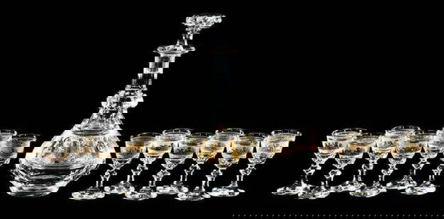 A 13 Pc. Val St. Lambert "Danse de Flore" Cordial Set: A 13 Pc. Val St. Lambert "Danse de Flore" Cordial Set. hand blown crystal decanter with gilded cameo decoration of a procession of classical figures, together with 12 cordials, gilded etched band of p