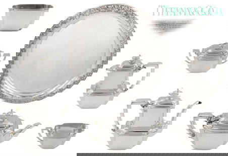 Set Of 7 Tiffany And Co. Sterling Silver Tea Set ( 5,179 grams ): Set Of 7 Tiffany And Co. Sterling Silver ( 5,179 grams ) Tea Set. Tray: D 18" \ Big teapot: H 8" \ Medium teapot: H 7 1/2" \ Small teapot: H 6" \ Sugar bowl with lid: H 5" x W 3 1/2" x L 6 1/2" \ Crea