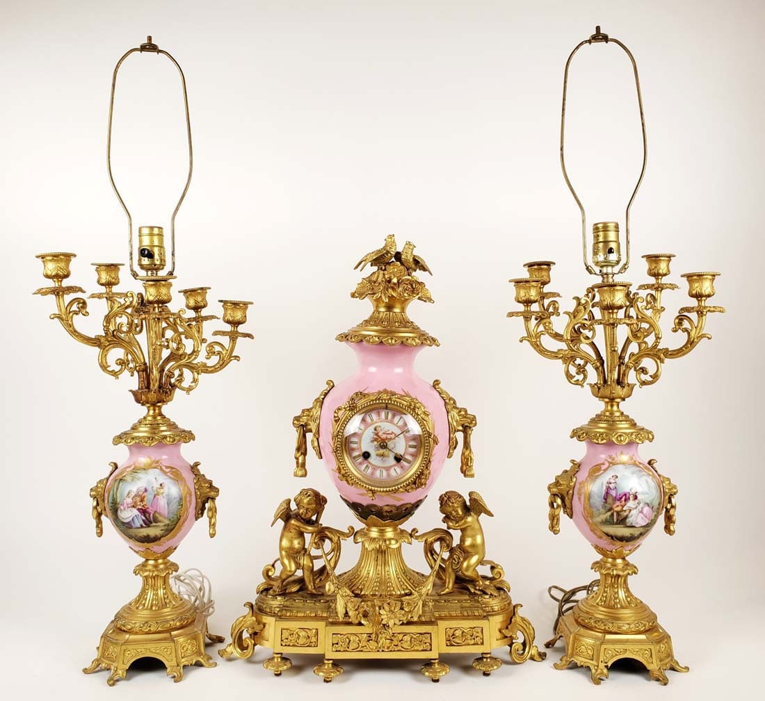 19th C. Sevres Porcelain & Gilt Bronze Figural Clockset: 19th C. Sevres Porcelain & Gilt Bronze Figural Clockset. The clock measures H: 21" W: 16 1/4" and the candelabras measure H: 31 1/2" W: 9 1/2"