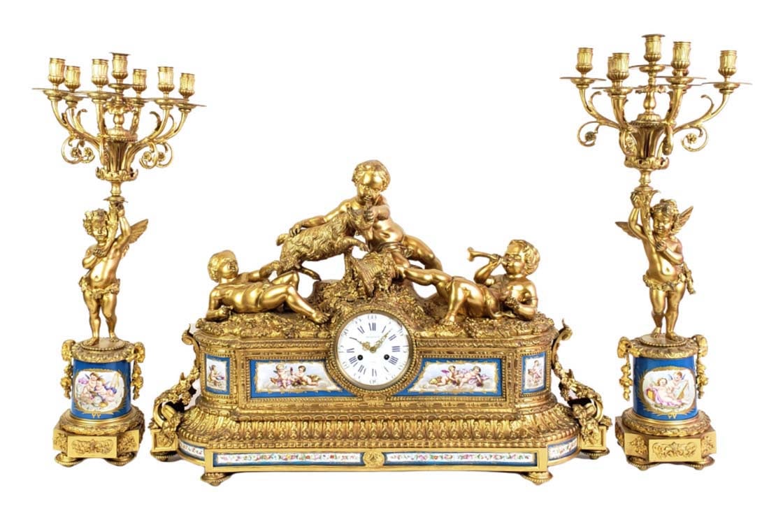 A Monumental 19th C. French Sevres Tiffany & Co. Gilt Bronze & Porcelain Clockset: A Monumental 19th C. French Sevres Tiffany & Co. Gilt Bronze & Porcelain Clockset. The clock measures H: 22 1/2" W: 34" and the candelabras measure H: 30 3/4" W: 12 3/4". The plaques are signed on