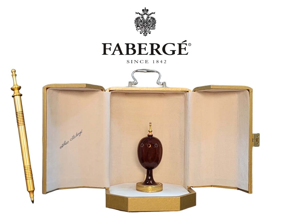 Numbered Theo Faberge Wood Egg Pen Holder With Ruby: The Scribe Egg was the first of Theo FabergÃ©'s creations for The St. Petersburg Collection. It is made from cocobolo wood, a rare and exotic wood from Central America. The Egg is inset with rings, 