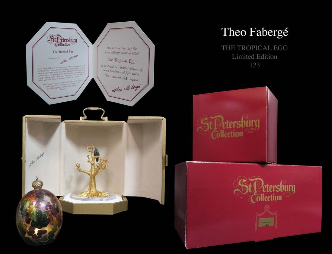 THEO FABERGE "THE TROPICAL EGG", WITH DISPLAY CASE: Theo Faberge (English, 1922-2007). "The Tropical Egg", a hand decorated glass egg and tree-shaped gilt metal base. Maker's mark underneath on sterling plaque with British hallmarks and No. 123 (of 750