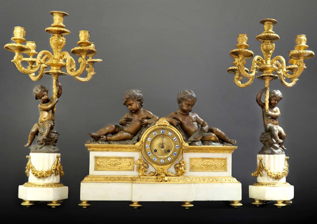 19th C. Figural Bronze And White Marble Clock Set With Pair of Candelabras: 19th C. Figural Bronze And White Marble Clock Set. Clock: H 15" x L 20" x W 5.5 / Candelabras: H 24.5 x W 5.5"