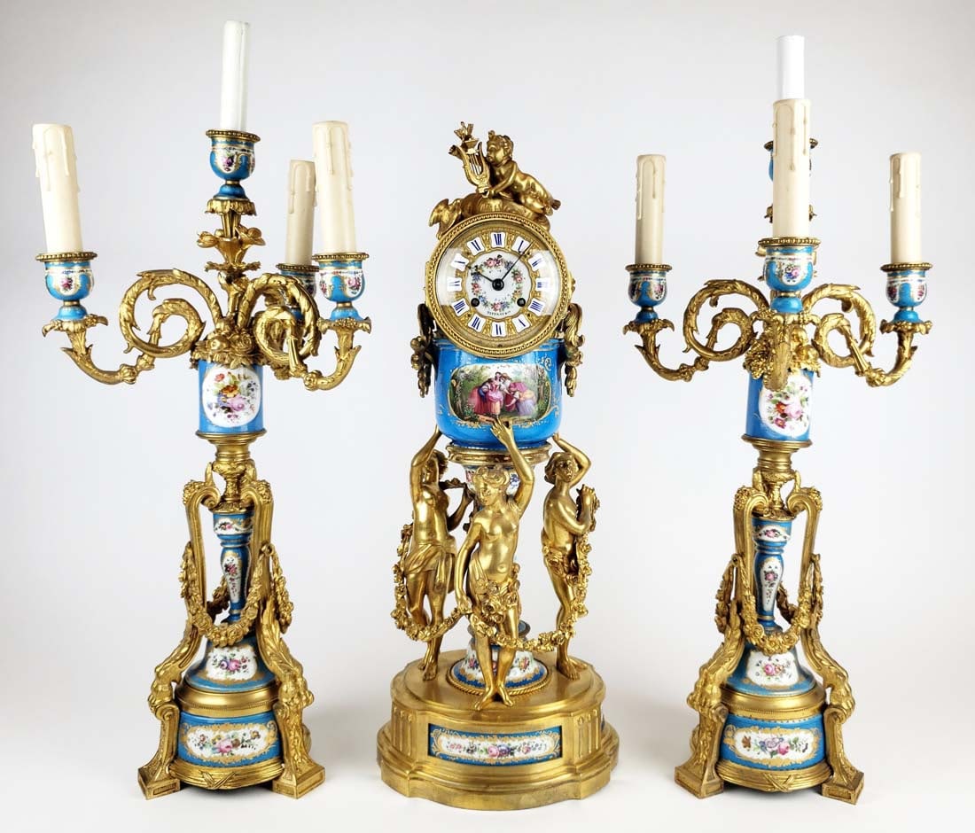 19th C. Sevres Tiffany & Co. French Porcelain & Gilt Bronze Clockset: 19th C. Sevres Tiffany & Co. French Porcelain & Gilt Bronze Clockset. The clock measures H: 22 1/4" W: 8 3/4" an the candelabras measure H: 25 1/4". Clock is signed Tiffany and Co.