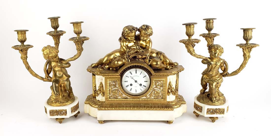A 19th C. Tiffany & Co. Gilt Bronze & Marble Figural Clockset: A 19th C. Tiffany & Co. Gilt Bronze & Marble Figural Clockset. The clock measures H: 14 3/4" W: 16 1/4" and the candelabras measure H: 15 1/4" W: 11 1/4"