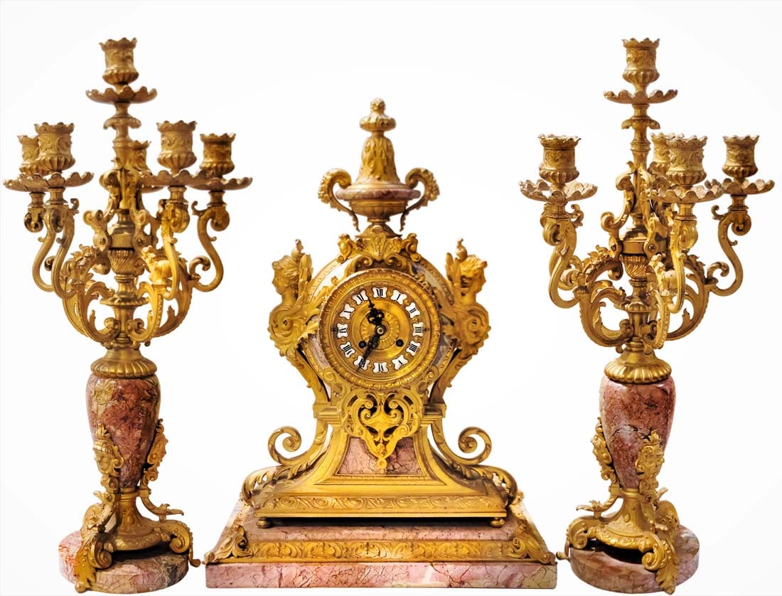 19th C. French Rouge Marble Figural Bronze Clock set: 19th C. French Rouge Marble Figural Bronze Clock set. Clock: H 19 1/2" x W 8 3/4" x L 14" \ Candelabras: H 21 1/4" x W 10"
