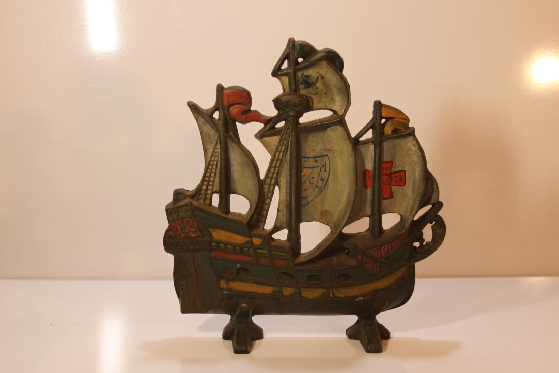 Cast Iron Doorstop Schooner with paint: A decorated cast iron doorstop, three masted ship, 11 x 11 1/2"