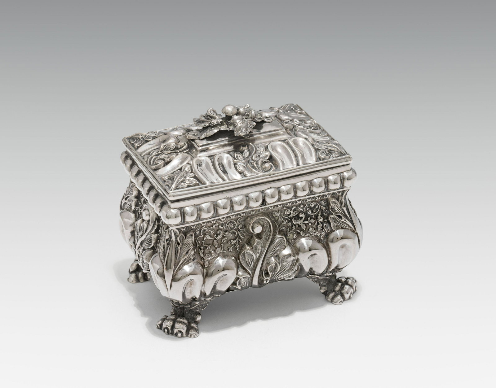 Sugar Boxsilver, gilded inside; rectangular form, 4 paw feet; wall with rich acanthus leaf and: Sugar Boxsilver, gilded inside; rectangular form, 4 paw feet; wall with rich acanthus leaf and tendril decoration; marked on the lid and on the reverse: Old-Viennese hallmark "1844" and marked "AB"h. 