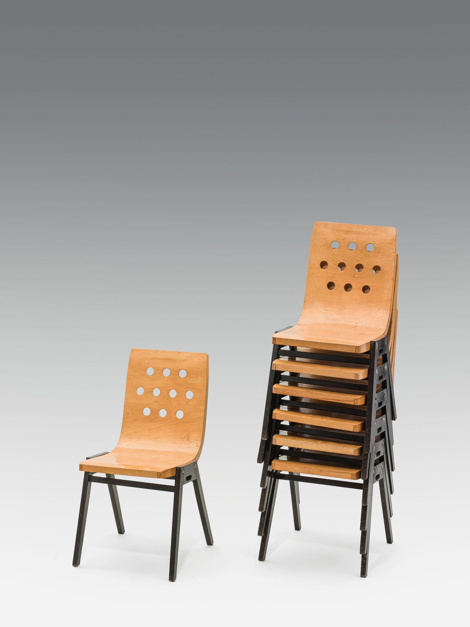 Roland Rainer: 7 Stacking chairs "3/4/3": Roland Rainer 7 Stacking chairs no. "3/4/3" for the Wiener Stadthalle beech wood, solid and curved, painted colourless and black h. 85.5 cm; seat height 44.6 cm