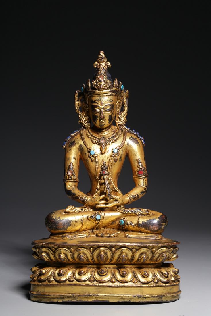 GILT BRONZE CAST BODHISATTVA SEATED FIGURE: The gilt bronze figure depicts Bodhisattva seated on the double lotus throne pad in dhyanasana, hands raised at chest level in mudra, lotus flowers stem upwards from the arms, eyes open in serene expr