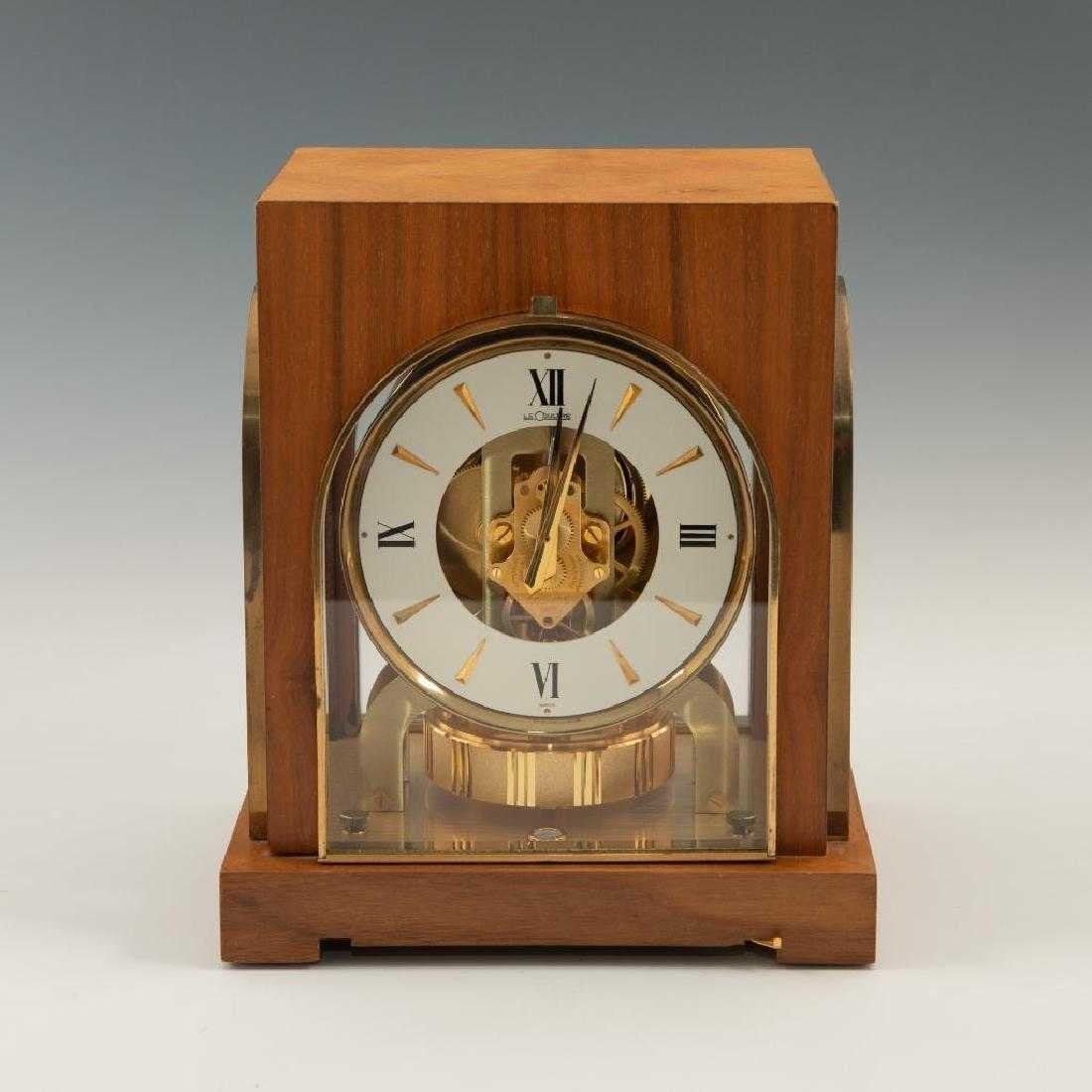 LeCoultre Cosmos Atmos Clock Swiss Made No Winding: Beautiful large clock. Working perpetual timepiece in beautiful walnut case with brass furniture. A Swiss made desk model with bubble level and adjustable feet for supreme accuracy and balance. Powere