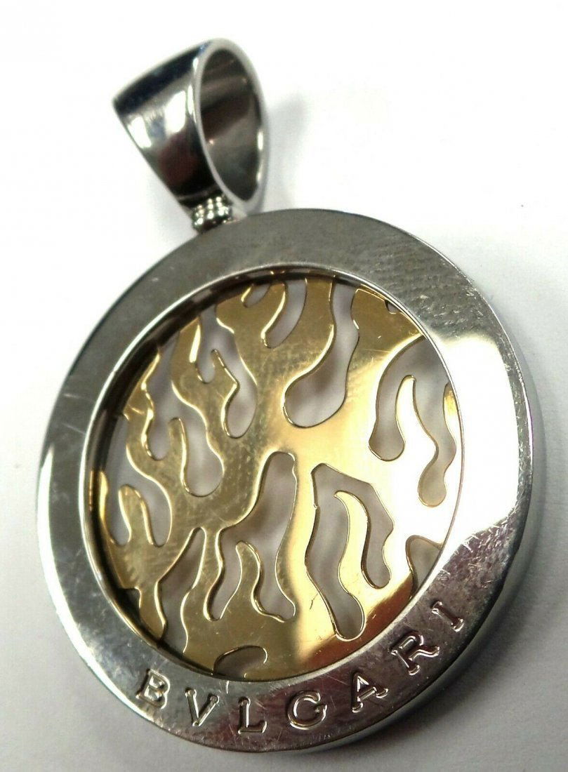 Bvlgari Tondo Fire 18k Gold Pendant Made in Italy: Bulgari Tondo Fire 18k Gold and stainless steel Pendant made in Italy. Weight: 11.4 gr /7.0 Dwt. Charm Length: 4.3 cm. Charm Width: 3.1 cm. Estimated retail price $1,740. In house shipping to continen