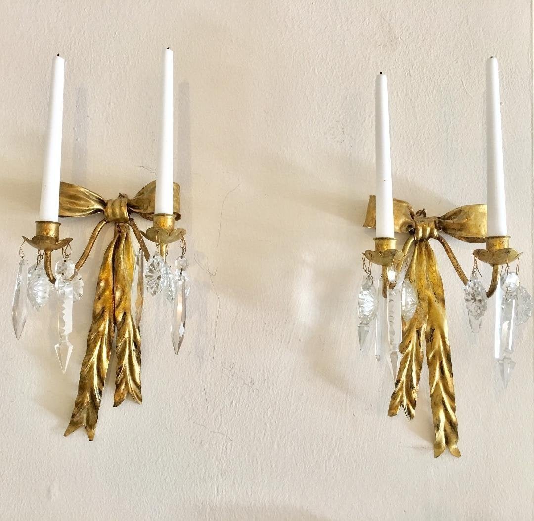 Pair Vintage Italian Gilt Metal Cut Crystal Candelabras: Pair of Vintage Italian Gilt Metal Cut Crystal Wall Bow ties Candelabras. Signed "Italy". Each Measures 12.5"H x 7"W. In house shipping is available, buyer pays shipping cost.