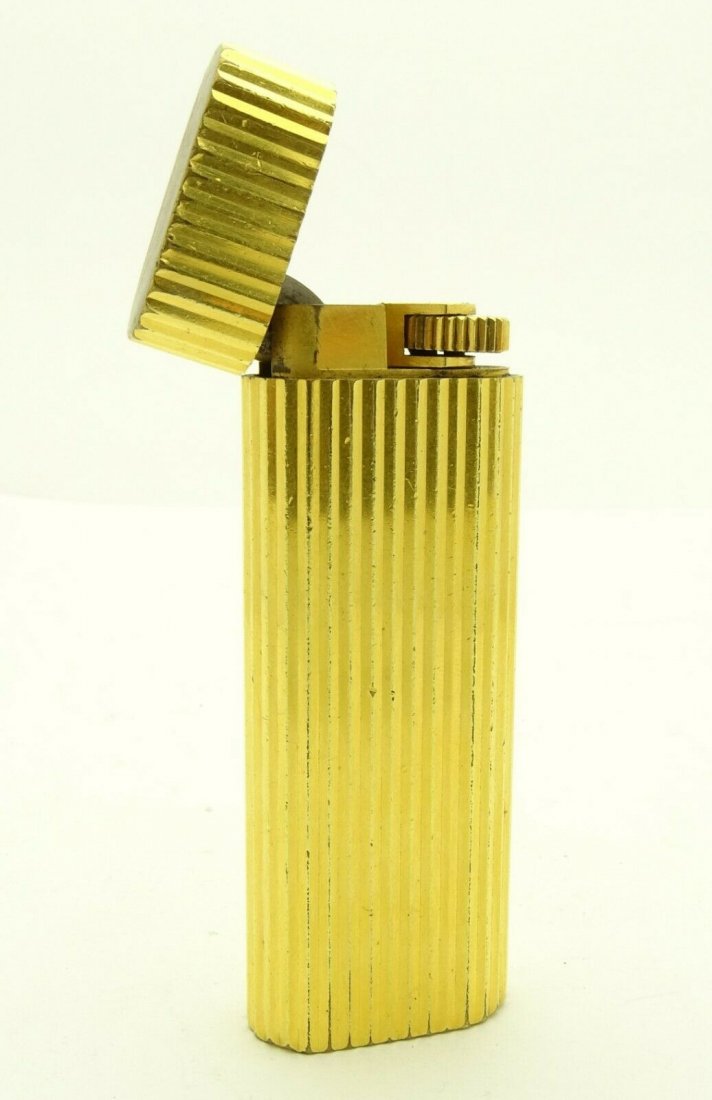 Vintage Cartier Gold Plated Striped Oval Lighter: Vintage Cartier Gold Plated Striped Oval Lighter size: apprx 2.8"H/ 1.2" L/ 0.5" W. In house shipping to continental US $15.