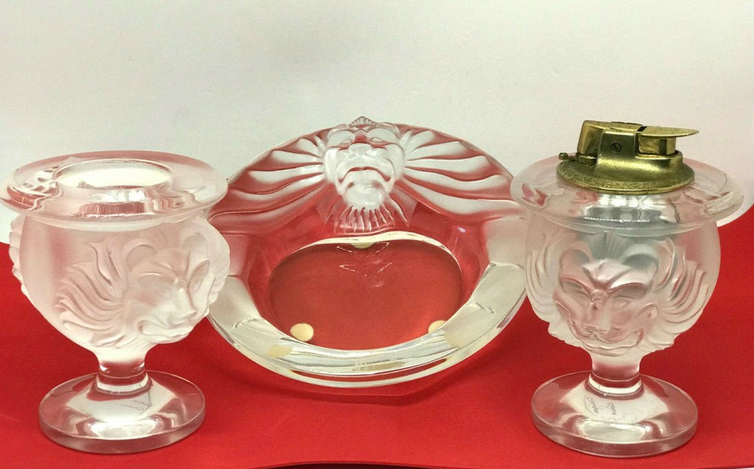 Lalique France Frosted Crystal Tete De Lion Set Lighter: Lalique France Frosted Crystal Tete De Lion Set Lighter, Ashtray and Cigarette Holder. Ashtray is 5.75"Dia, Lighter and Holder are approx. 4"H. All signed on the bottom. In house shipping is available