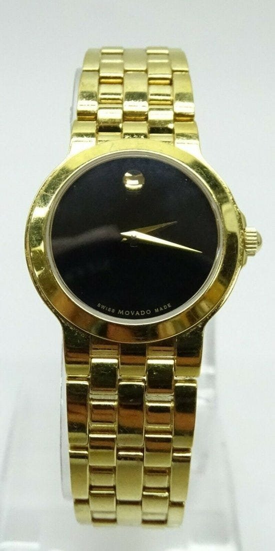 Movado Watch 88 E4 1855 Classic Black Dial Gold Tone: Movado 88 E4 1855 Classic Black Dial Gold Tone Ladies Watch. Case size: 30mm. Case Material: Stainless steel. Movement: Quartz. weight: 60.5 g/38.9 dwt. In house shipping is available, buyer pays ship