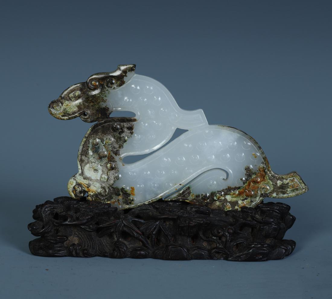 A Finely Carved Chinese White and Russet Jade Animal: H.9 cm. L.12 cm. W.3.5 cm. Weight.90 gram.