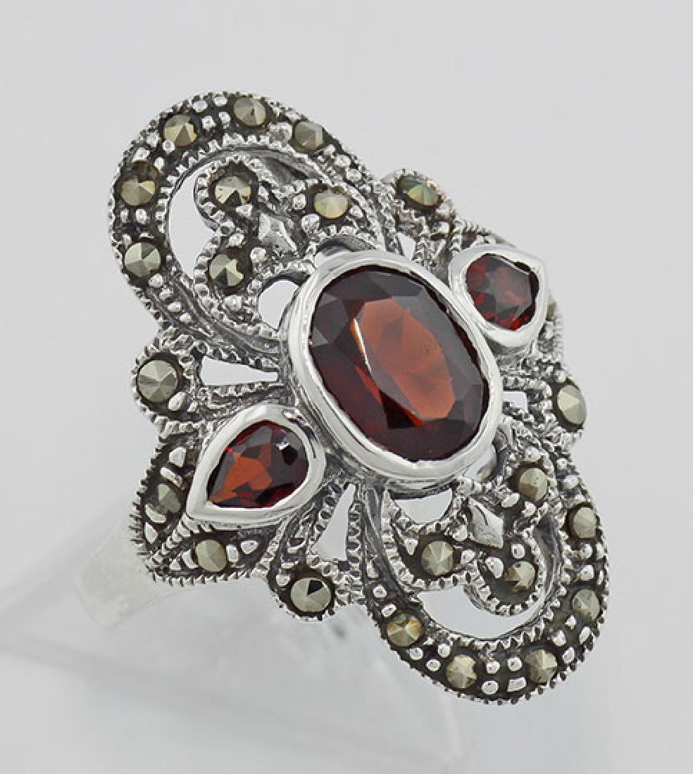 Garnet and Marcasite Ring - Sterling Silver: Garnet and Marcasite Ring - Sterling Silver **|**|** #R-387-G Metal : Sterling Silver | Stone : Garnet Marcasite | Style : Ring | Height : 3/8 inch | Width : 5/8 inch | Approximate Weight : 6 grams | 