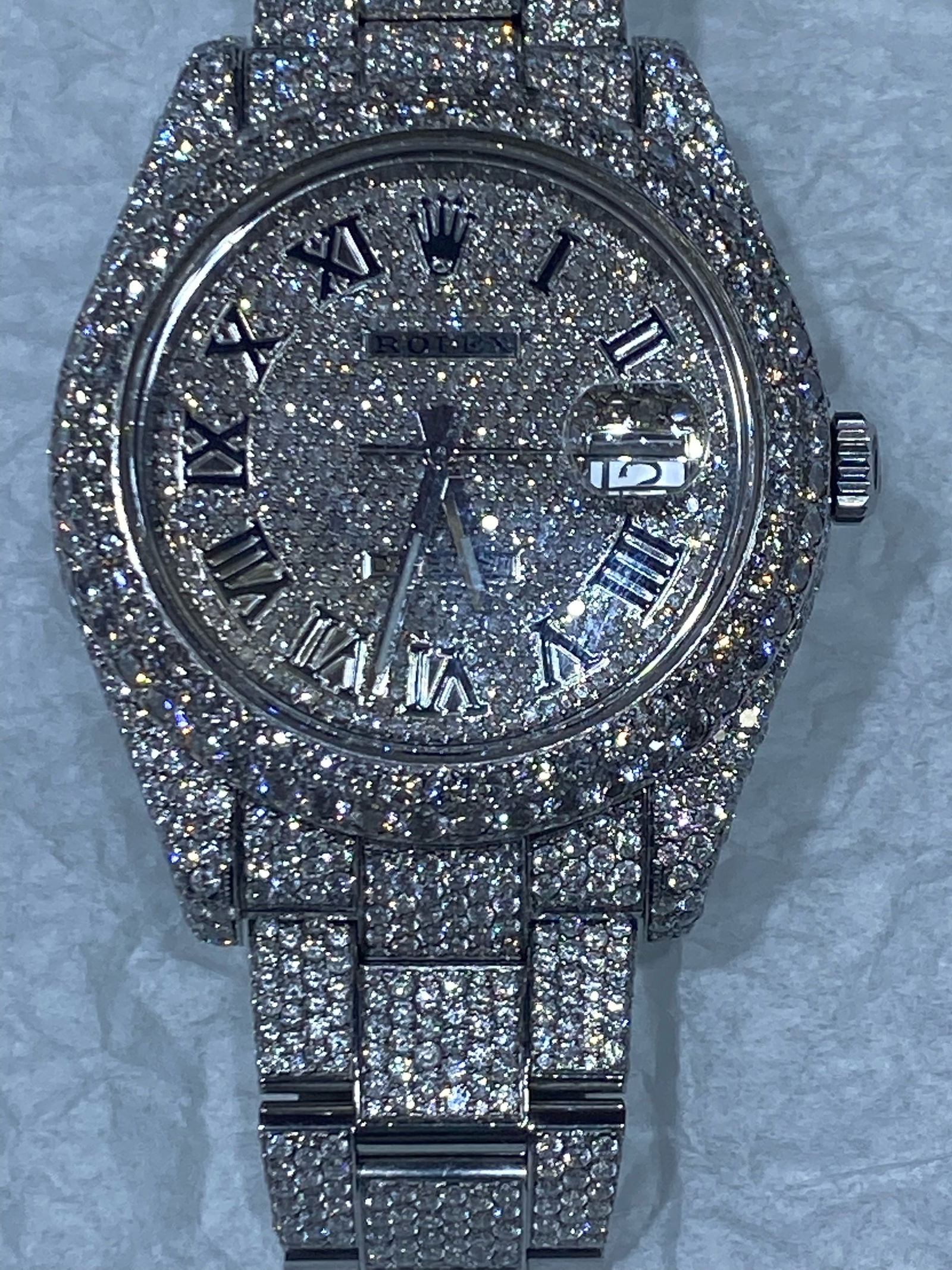 CUSTOM OYSTER PERPETUAL ROLEX WITH 25 CTTW DIAMONDS: TYPE: ROLEX STYLE: OYSTER PERPETUAL CONDIIONT: VERY GOOD (USED) DIAMOND CTW: 25 CTW; DIAMOND COLOR: G-H DIAMOND CLARITY: SI1 COMES WITH PAPERS AND CERTIFICATE #PAPPS69606v7