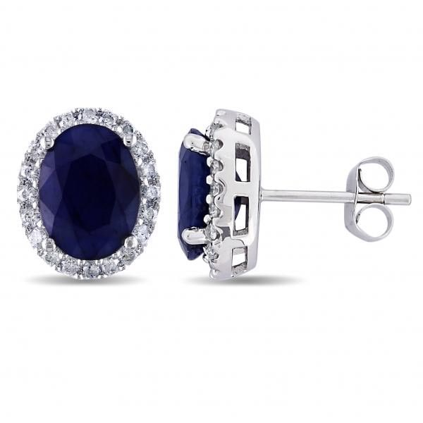 Oval Blue Sapphire and Halo Diamond Stud Earrings 14k W. Gold 5.70ctw: CENTER STONE; Blue Sapphire CENTER STONE CLARITY; Eye Clean CENTER STONE COLOR; Blue CENTER STONE SETTING; Prong SIDE STONE CLARITY; SI1-SI2 SIDE STONE COLOR; J-K SIDE STONE SETTING; Pave ctw OF SIDE