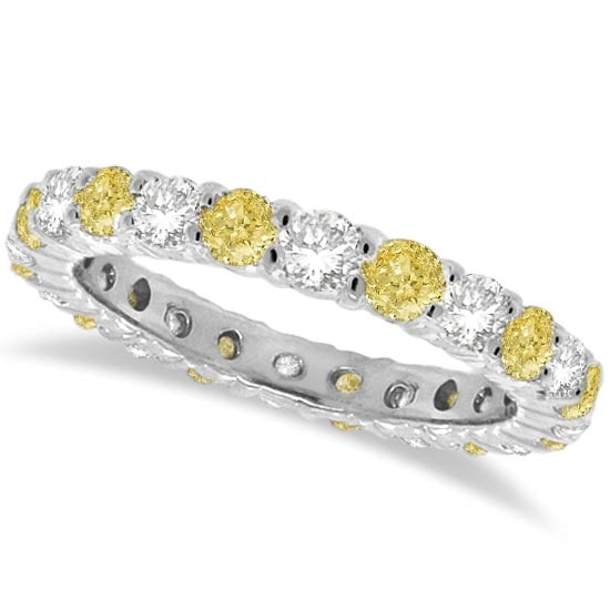 Fancy Yellow Canary and White Diamond Eternity Band 14k Gold 1.07ctw: CENTER STONE; Diamond CENTER STONE CLARITY; SI CENTER STONE COLOR; Yellow CENTER STONE SETTING; Prong SIDE STONE CLARITY; SI SIDE STONE COLOR; J-K SIDE STONE SETTING; Prong ctw OF SIDE STONE: 0.5 SIDE