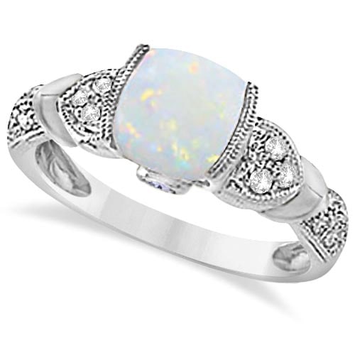 Tanzanite, Diamond and Opal Ring 14k White Gold 1.10ctw: CENTER STONE; Opal,Tanzanite CENTER STONE CLARITY; CENTER STONE COLOR; White,Pink CENTER STONE SETTING; Semi-bezel,Bezel SIDE STONE CLARITY; SI SIDE STONE COLOR; J-K SIDE STONE SETTING; Pinpoint ctw O