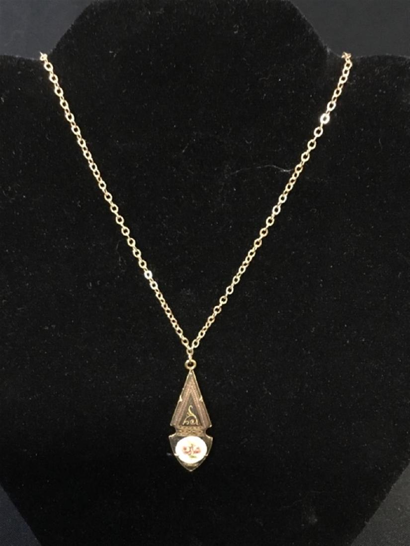 14 karat gold necklace with a Victorian gold tone charm (1 of 1)
